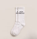 A pair of white Genetics crew socks with the black GENETICS mark
